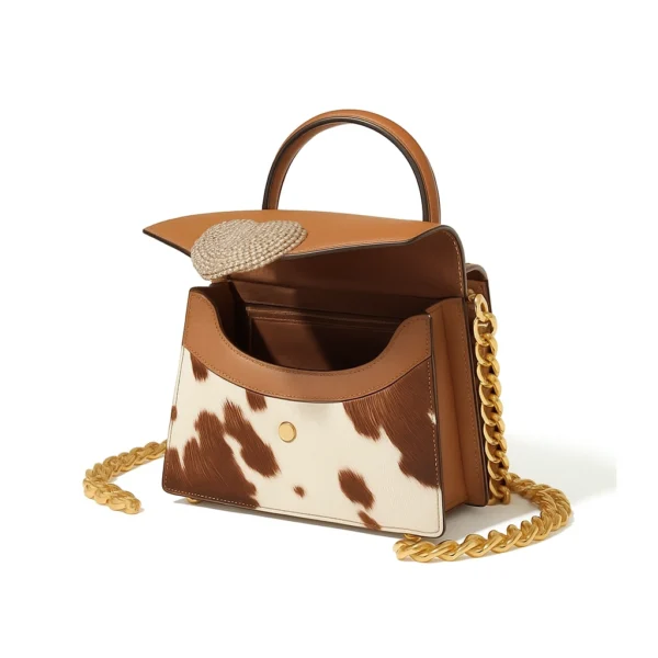 Charming heart-shaped cowhide leather purse in soft pink with white decorative stones featuring a kiss-lock closure and elegant design