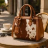 Elen Cowhide Bag 2 Luxurious brown quilted cowhide Elen bag with diamond pattern stitching and gold hardware displayed on white background
