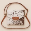 Roxana Cowhide Belted Bag 2 Roxana cowhide belted bag side view with western belt detail